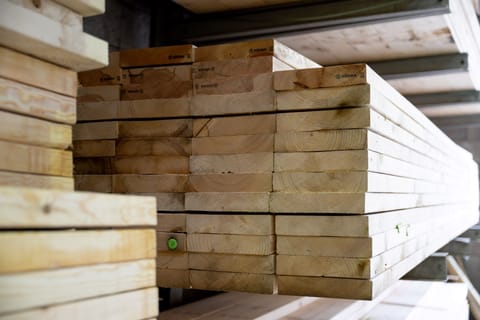 Wood planks stacked in a warehouse.