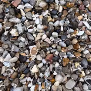 The ground is covered with Moonstone Flint Gravel (20mm), featuring an assortment of colors and shapes with both smooth and rough textures.