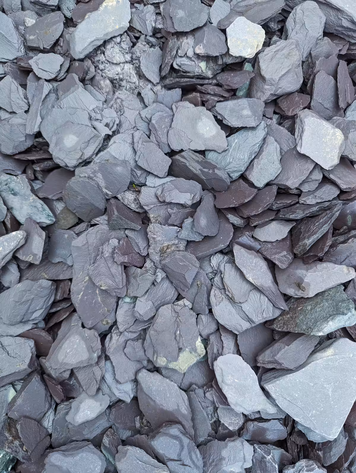 A pile of grayish rocks and stones of varying sizes and shapes densely packed together.